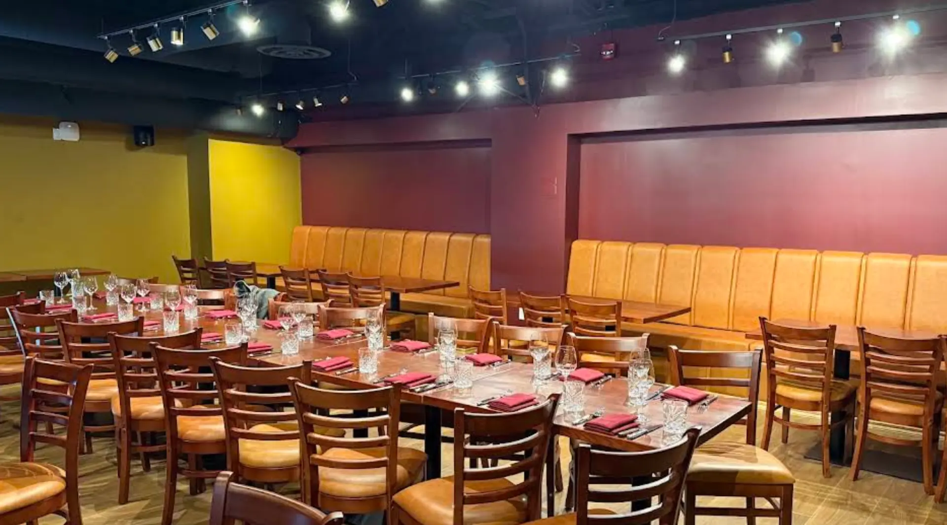 The dining room at Estrella del Mar, with long wooden tables and maroon walls